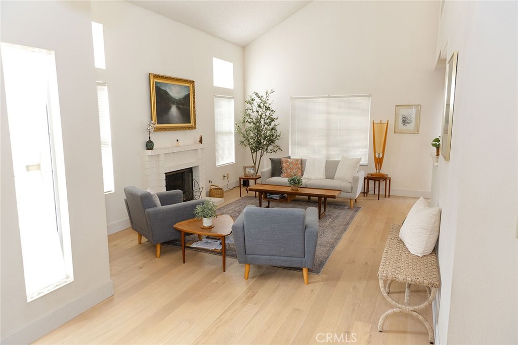 6059 Merion Court Banning, CA 92220 - Photo 9 of 48 a living room with furniture fireplace and a large window
