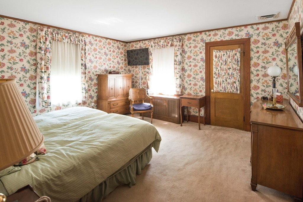 61 Ballard Street Newton, MA 02459 - Photo 13 of 22 a bedroom with a bed and wooden floor