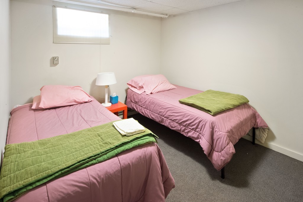 61 Ballard Street Newton, MA 02459 - Photo 19 of 22 a bedroom with two beds and chair