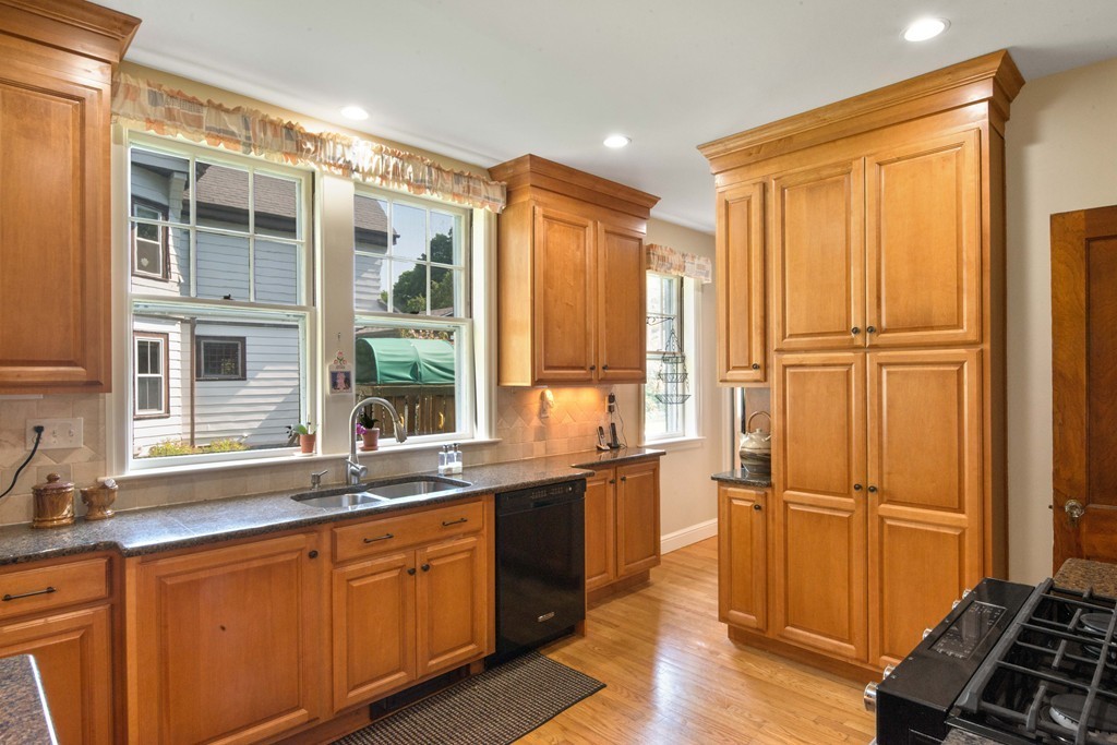 61 Ballard Street Newton, MA 02459 - Photo 8 of 22 a kitchen with stainless steel appliances granite countertop a refrigerator and a sink