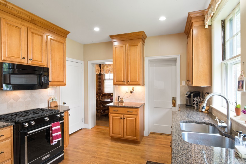 61 Ballard Street Newton, MA 02459 - Photo 9 of 22 a kitchen with stainless steel appliances granite countertop a stove a sink and a microwave