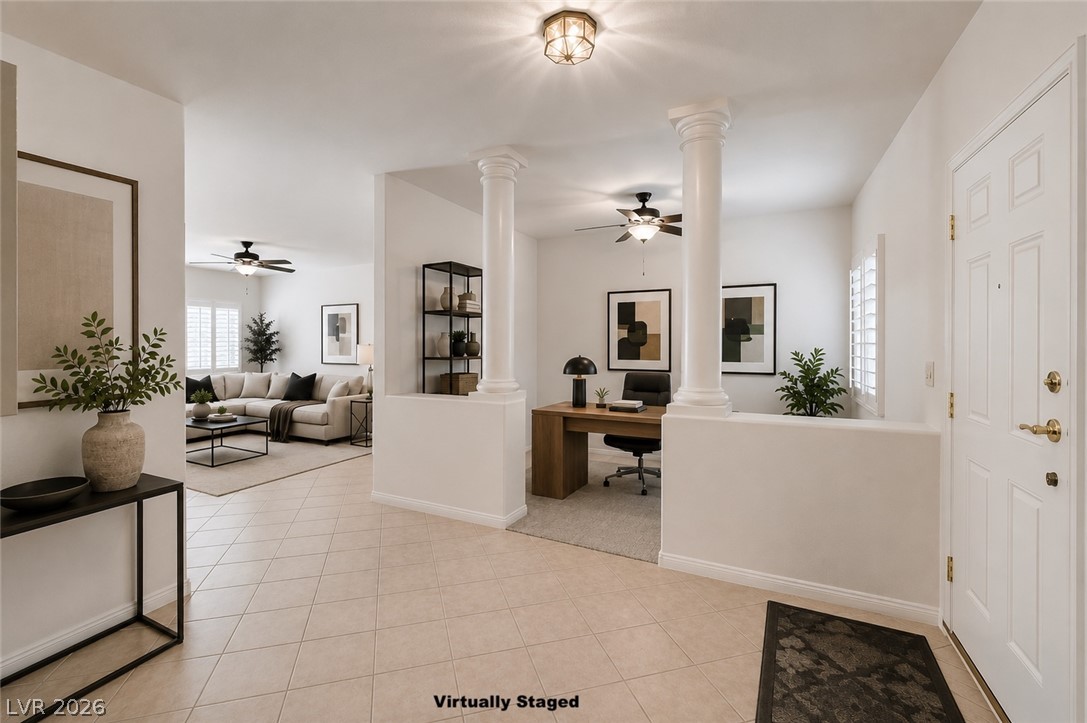 1479 Orange Jubilee Road Henderson, NV 89014 - Photo 2 of 36 The foyer leads to a well-lit living area and a dedicated home office space.