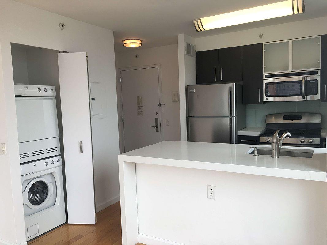 350 West 37th Street, Unit 16C Manhattan, NY 10018 - Photo 1 of 9 a kitchen with a refrigerator and a sink