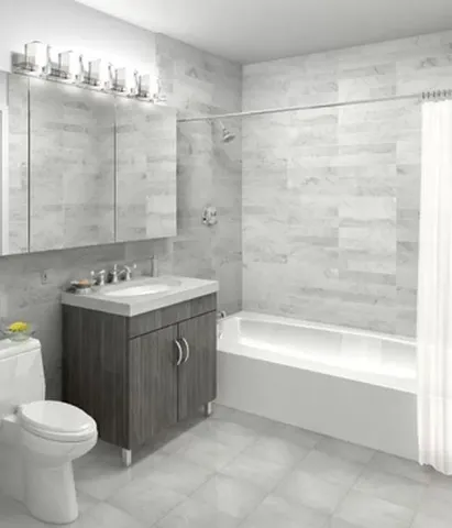 a bathroom with a sink vanity mirror bathtub and toilet