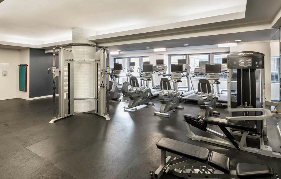 350 West 37th Street, Unit 16C Manhattan, NY 10018 - Photo 9 of 9 a gym room with lots of gym equipment