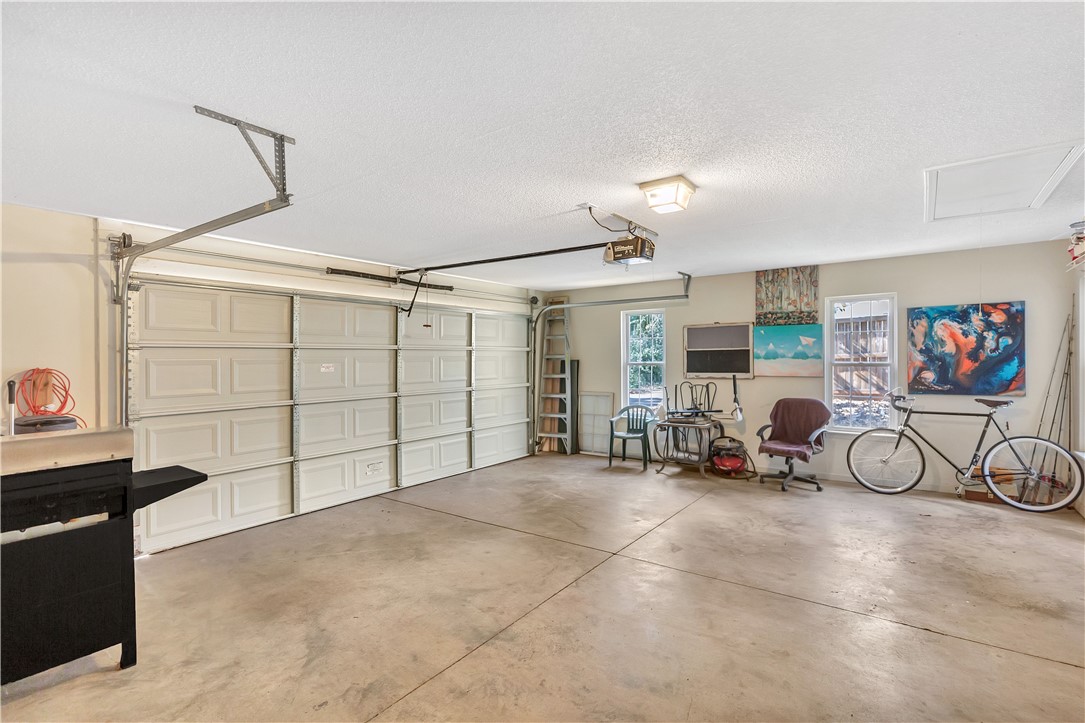 256 Rock Creek Road Clemson, SC 29631 - Photo 22 of 30 This spacious garage offers versatile space for vehicles, storage, and hobbies.