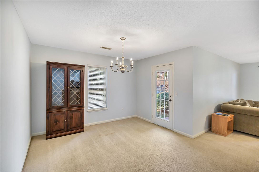 256 Rock Creek Road Clemson, SC 29631 - Photo 9 of 30 This bright space features ample natural light and a classic chandelier, offering a perfect setting for gatherings.