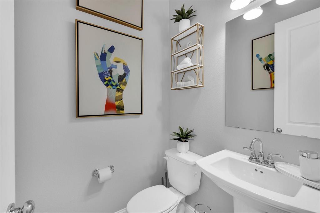 1498 Weston Road Dallas, TX 75234 - Photo 11 of 24 Pedestal sink with chrome fixtures and overhead vanity lighting