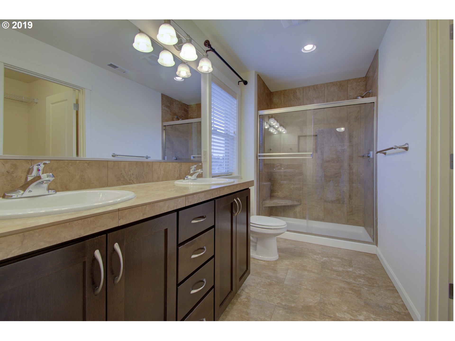 4013 North 5th Way Ridgefield, WA 98642 - Photo 13 of 26 a bathroom with a sink a toilet a mirror and shower