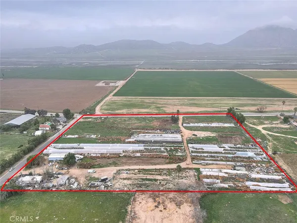 a view of a patio with table and chairs next to a yard