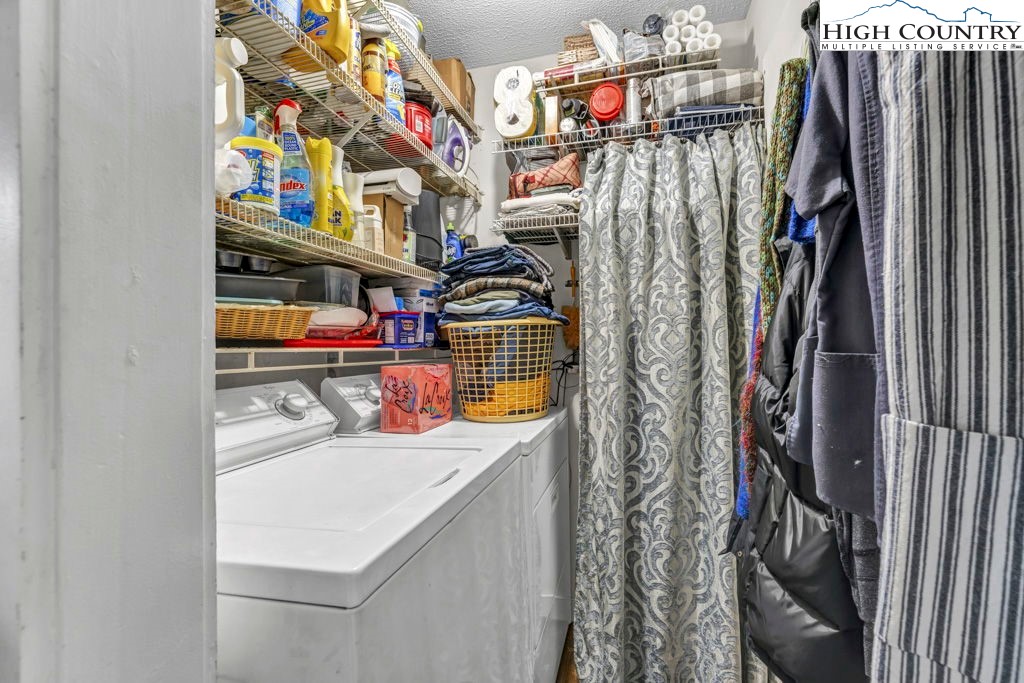 180 Wild Blackberry Hill Road Boone, NC 28607 - Photo 17 of 30 a view of walk in closet with clothes and shoes