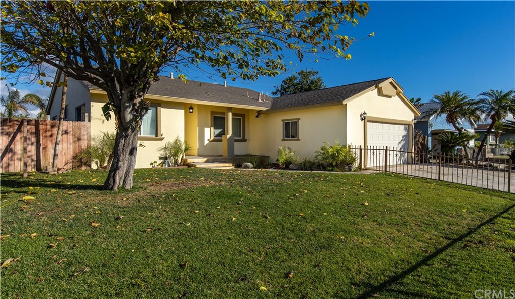 206 Grant Street Rialto, CA 92376 - Photo 1 of 1 Front yard with iron fencing, nice lawn and home freshly painted.
