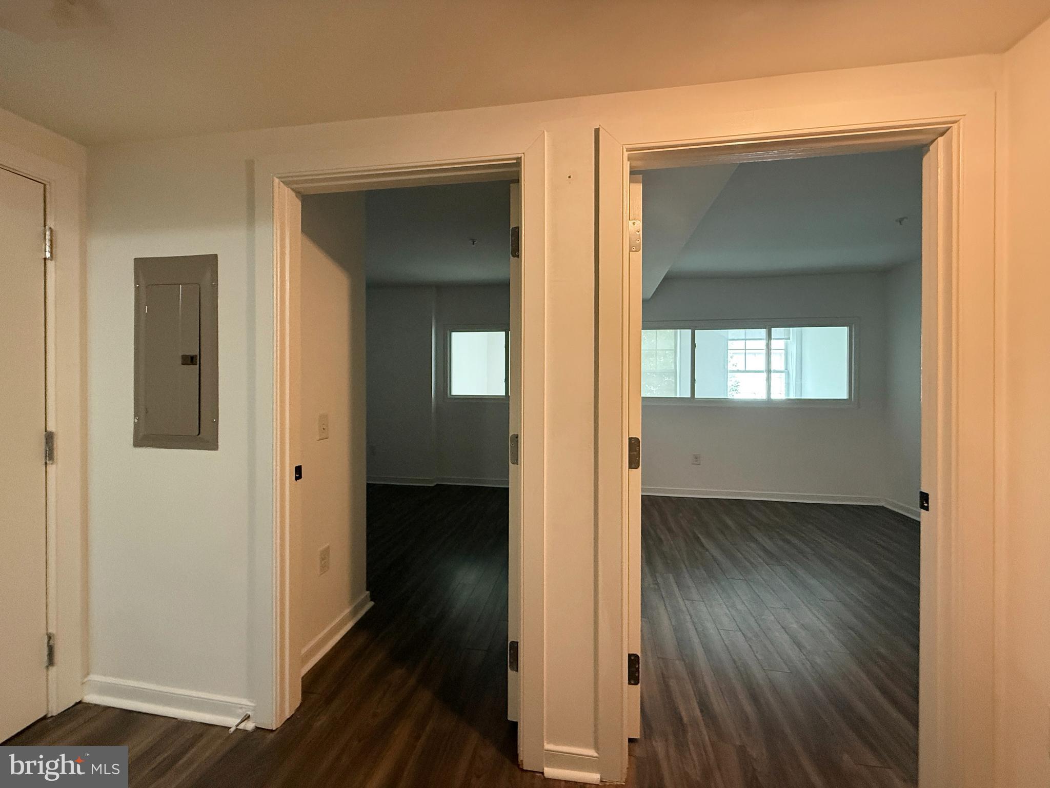 1250 9th Street Northwest, Unit 214 Washington, DC 20001 - Photo 14 of 27 a view of an empty room with wooden floor and a mirror