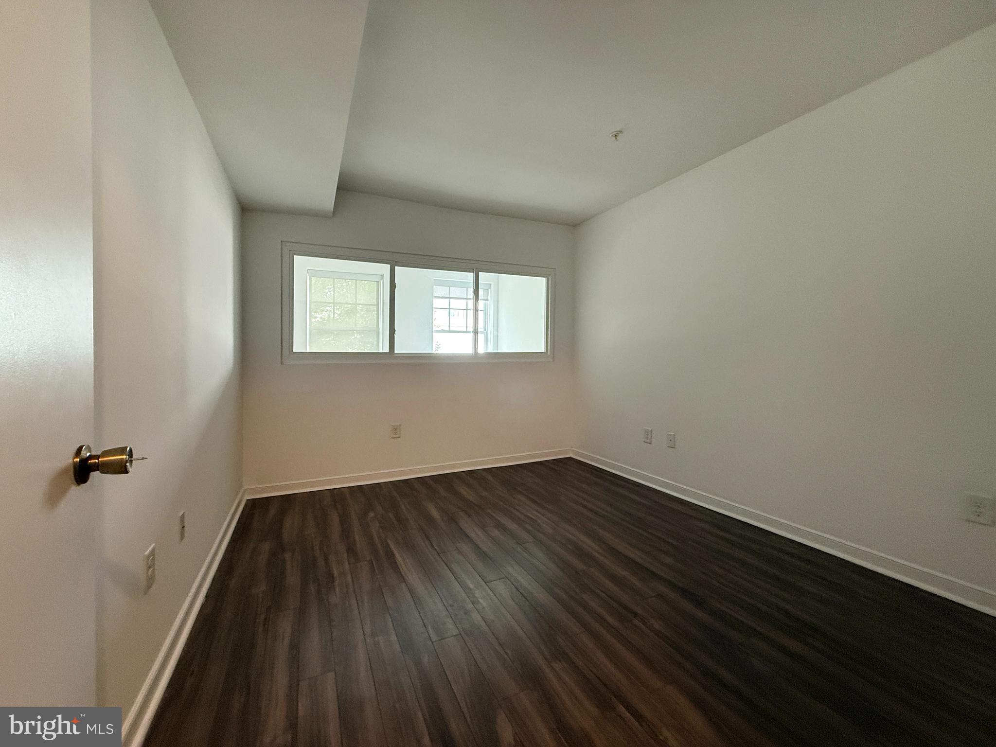 1250 9th Street Northwest, Unit 214 Washington, DC 20001 - Photo 15 of 27 an empty room with wooden floor and windows