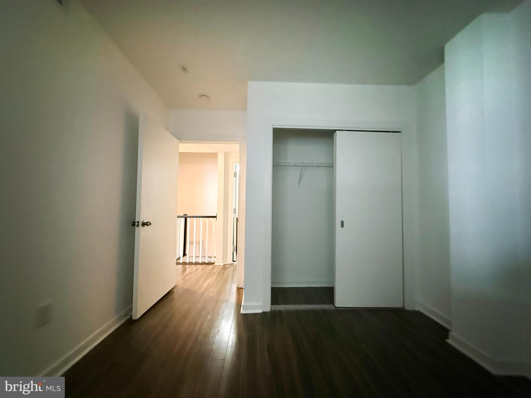 1250 9th Street Northwest, Unit 214 Washington, DC 20001 - Photo 19 of 27 an empty room with wooden floor door and windows
