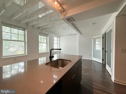 a kitchen with stainless steel appliances granite countertop a sink a oven and a large window