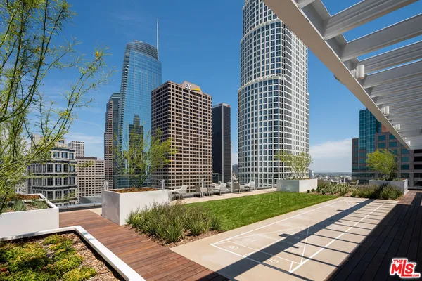 a view of a roof deck with couches and pool table and chair