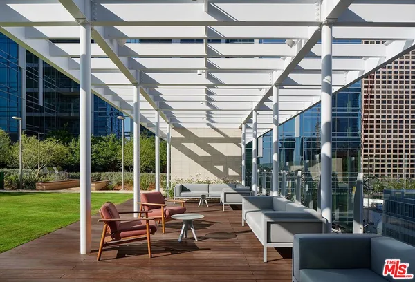 a view of a patio with couches and potted plants