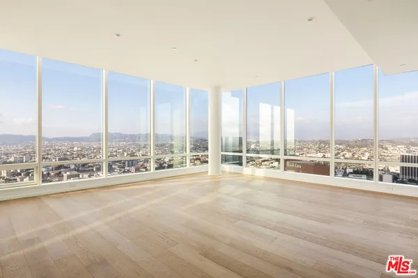 a view of an ocean with a floor to ceiling window