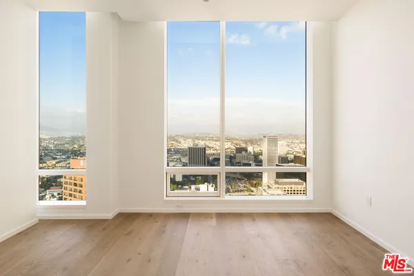 a view of a room with wooden floor and window