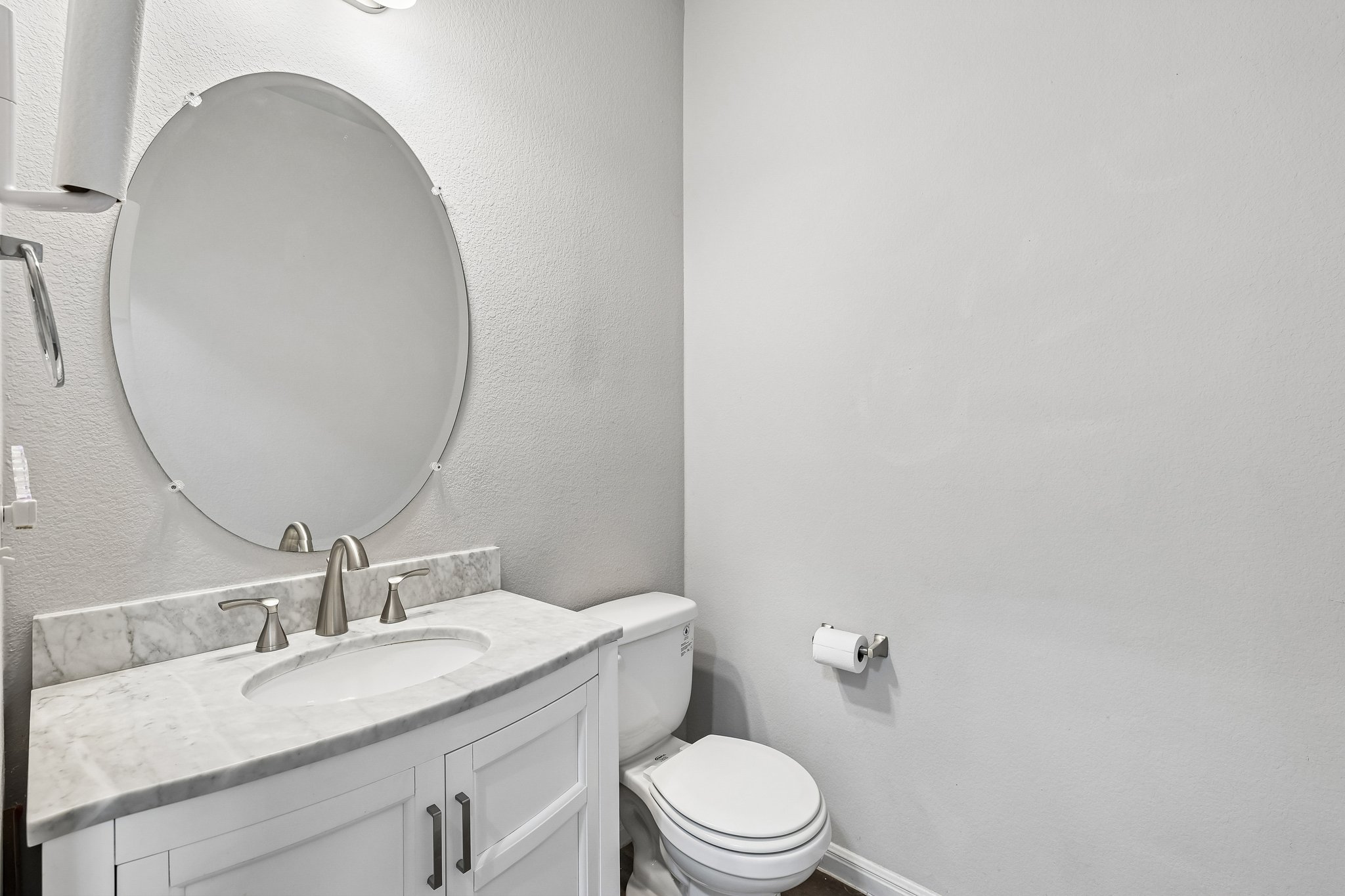387 Guemal Road Buda, TX 78610 - Photo 17 of 39 Vanity featuring a stone countertop, undermount sink, and brushed nickel fixtures