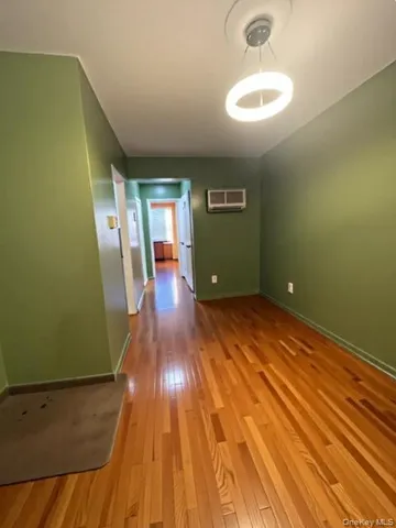a view of a room with wooden floor and a sink