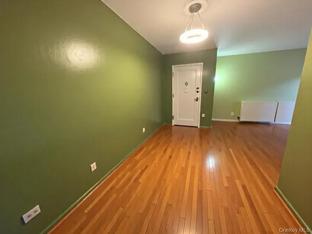 a view of a room with wooden floor and a sink
