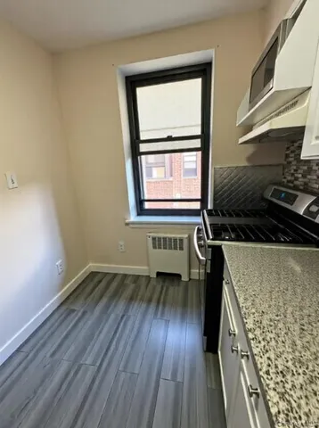 a kitchen with wooden floors and a stove