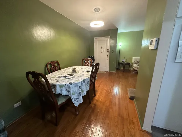 a dining room with furniture and wooden floor