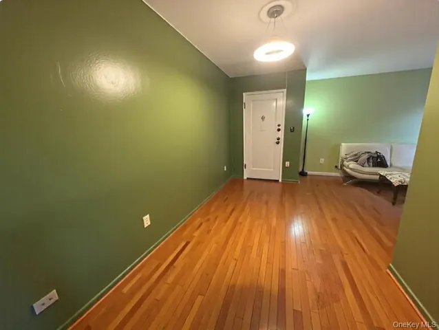 a view of a room with wooden floor