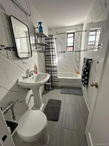 a bathroom with a sink toilet and mirror
