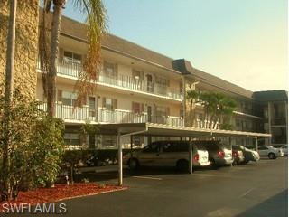 5499 Rattlesnake Hammock Road, Unit 204 Naples, FL 34113 - Photo 1 of 7 a front view of a building with street