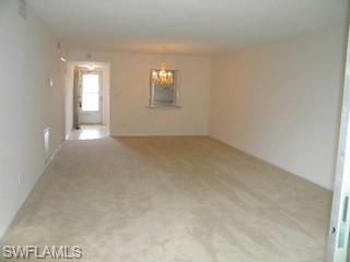 5499 Rattlesnake Hammock Road, Unit 204 Naples, FL 34113 - Photo 4 of 7 a view of an empty room with a window