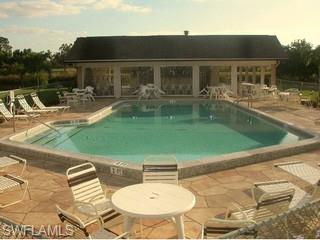 5499 Rattlesnake Hammock Road, Unit 204 Naples, FL 34113 - Photo 7 of 7 a backyard of a house with table and chairs