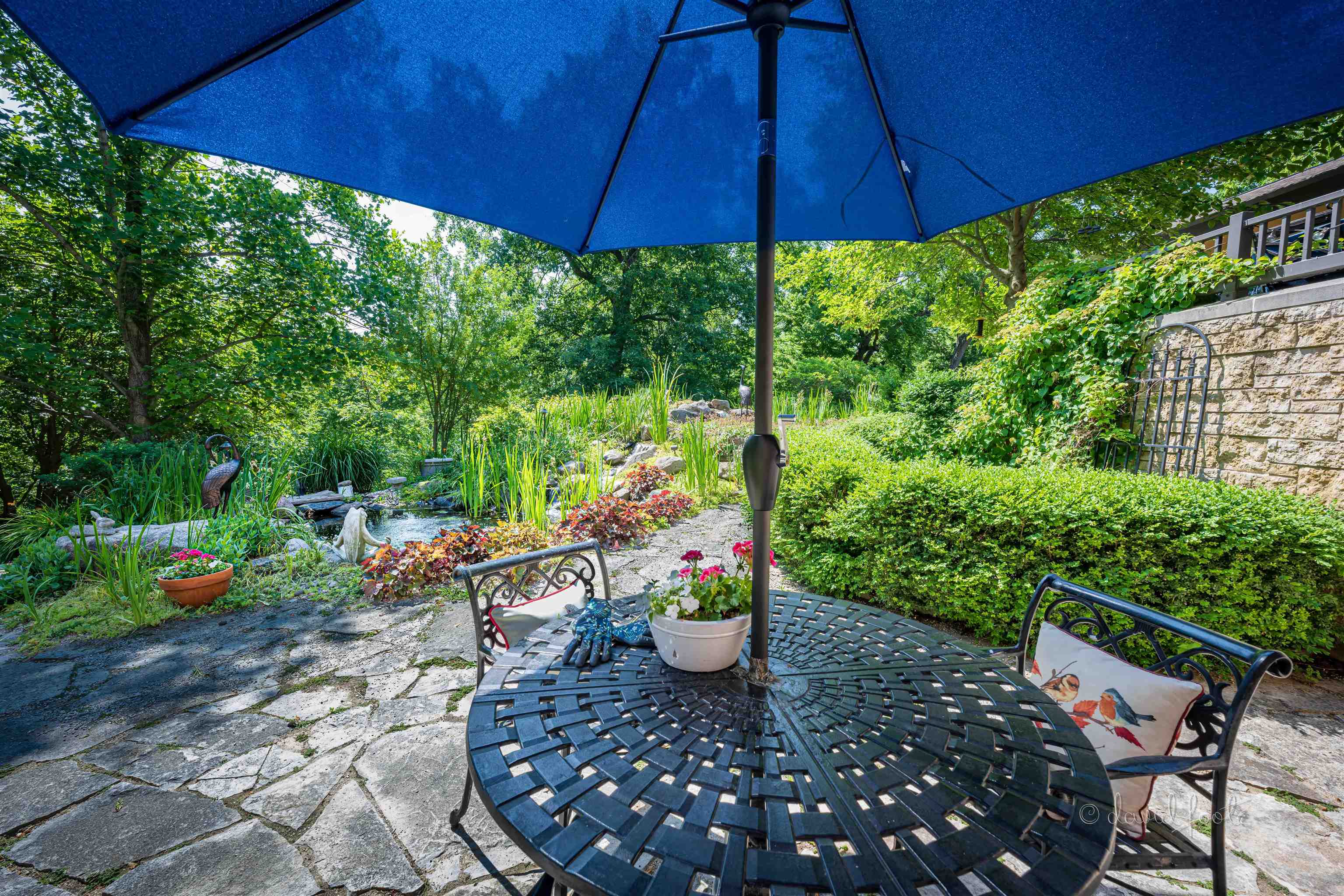 49 High Ridge Run Galena, IL 61036 - Photo 64 of 81 a view of a patio with table and chairs under an umbrella