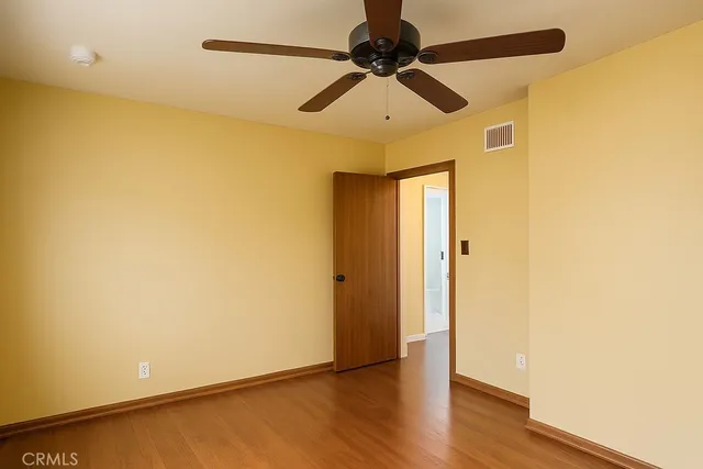 a view of a small space with wooden floor and a window