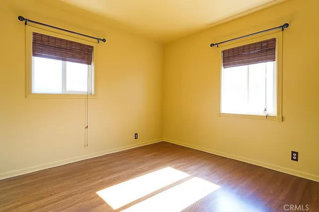 an empty room with wooden floor