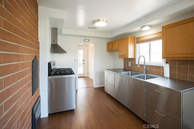 a kitchen with sink cabinets and wooden floor