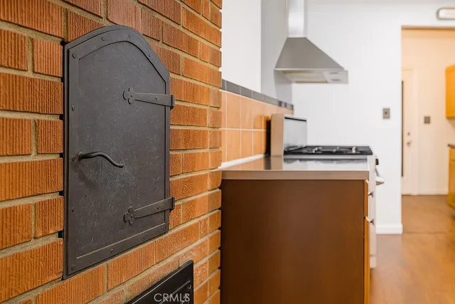 a view of empty room with wooden floor and fireplace