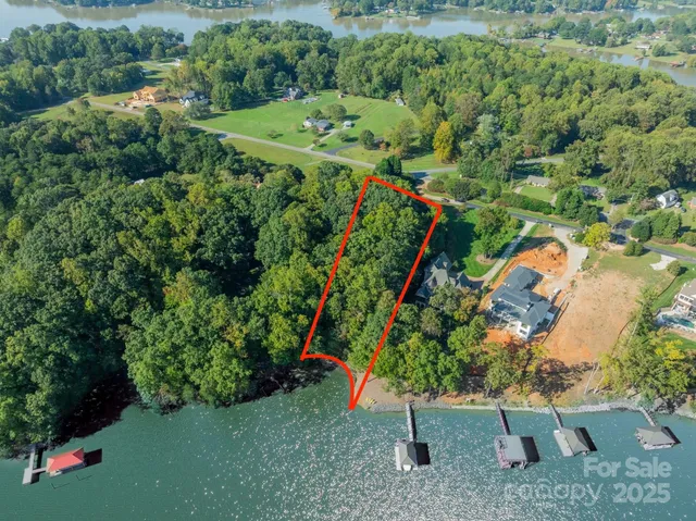 an aerial view of a house with a yard and outdoor seating