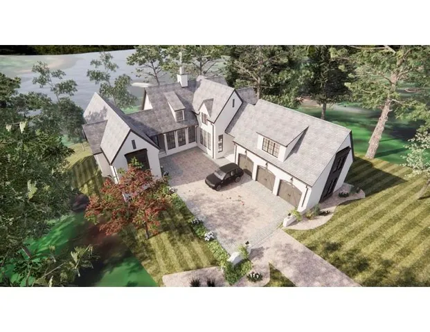 an aerial view of a house with a yard and outdoor seating