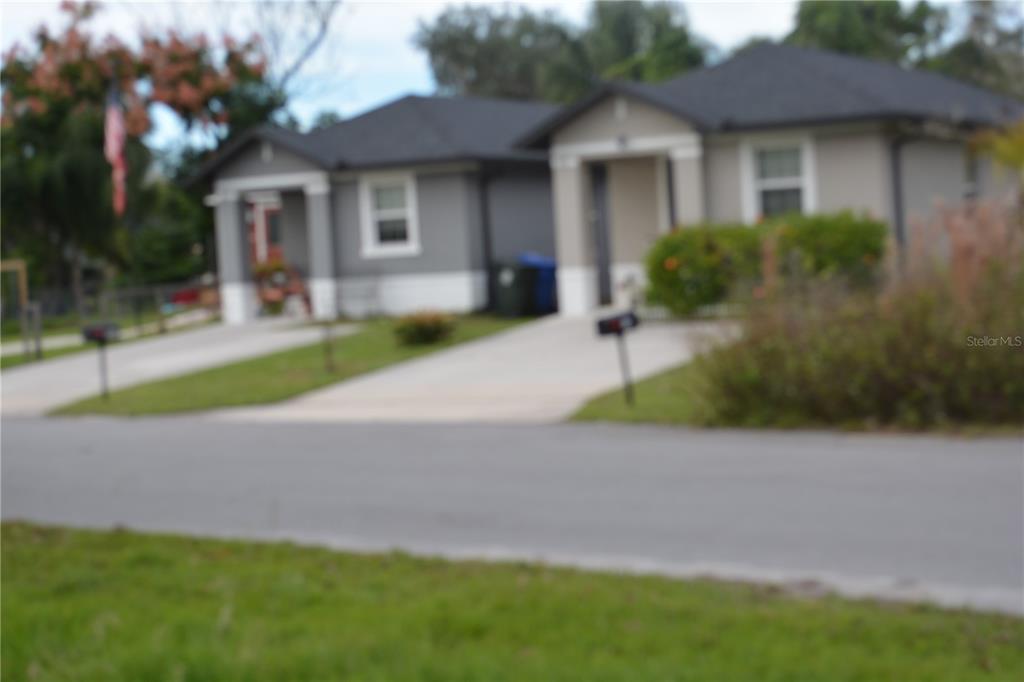 0 Chuluota Road Oviedo, FL 32765 - Photo 8 of 17 a front view of a house with a yard and potted plants