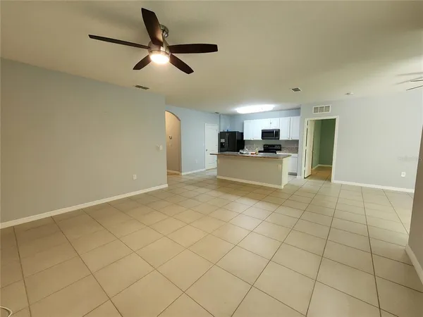 a view of a kitchen with furniture and a refrigerator