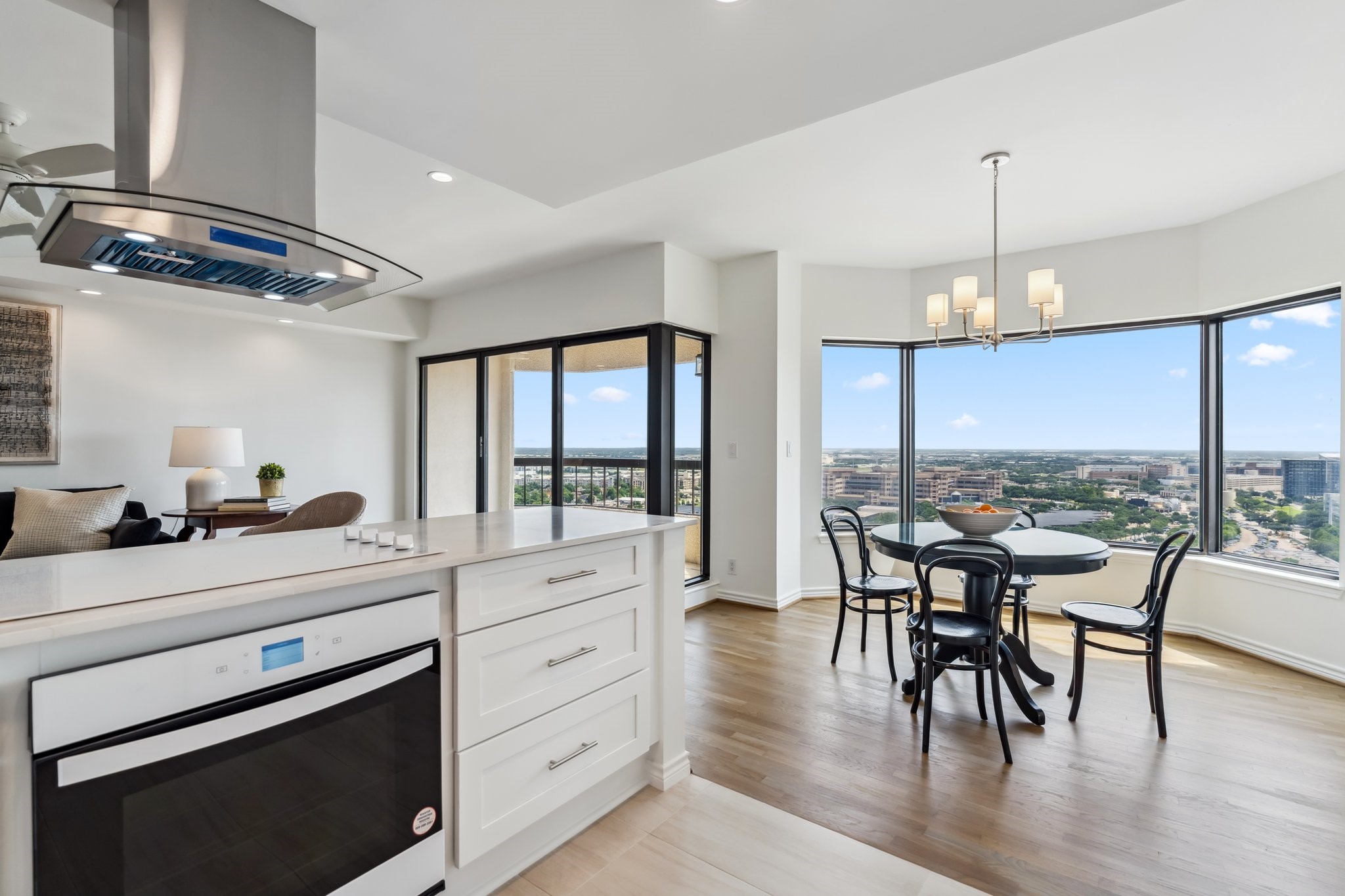 2001 Holcombe Boulevard, Unit 2305 Houston, TX 77030 - Photo 6 of 46 a kitchen with stainless steel appliances granite countertop a stove top oven a dining table and chairs with wooden floor