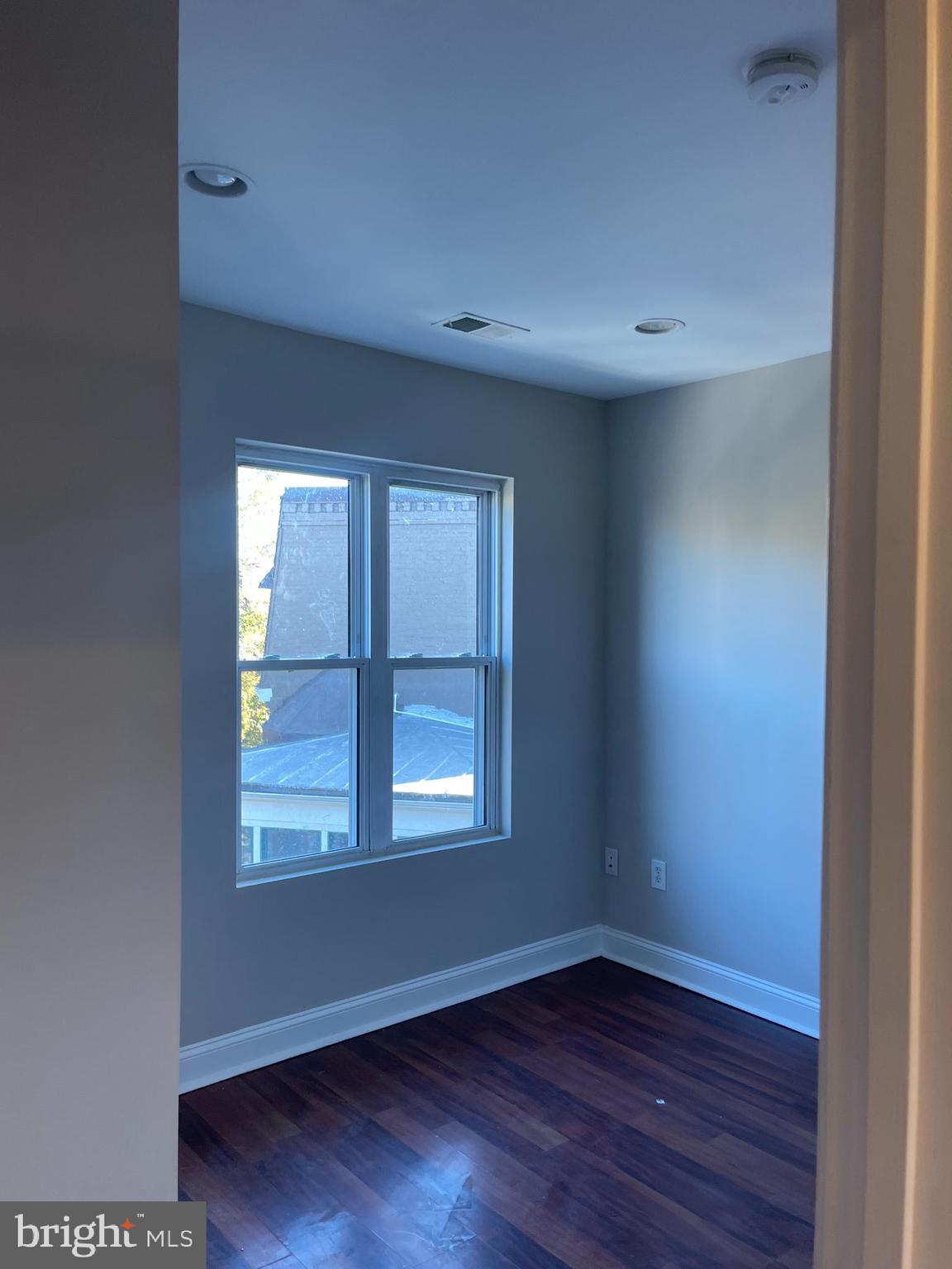 543 Florida Avenue Northwest, Unit 4 Washington, DC 20001 - Photo 2 of 7 an empty room with wooden floor and windows