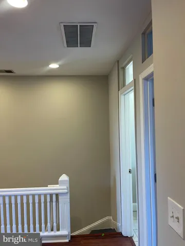 a view of a livingroom with wooden floor and a window