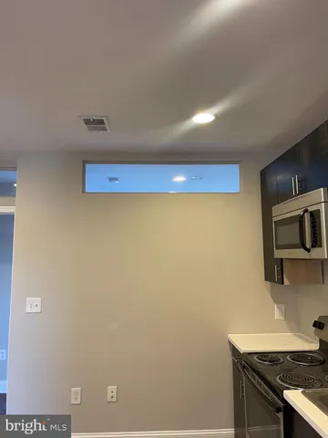 a kitchen with a sink and a stove top oven