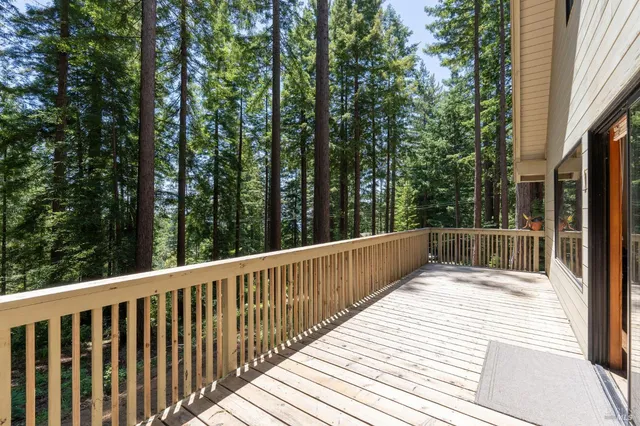 a view of balcony with deck and trees