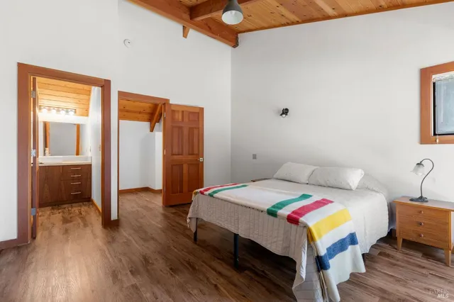 a bedroom with a bed and a table