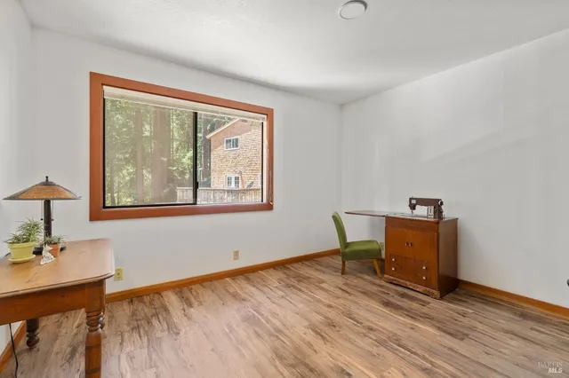 a view of a workspace with furniture and a window